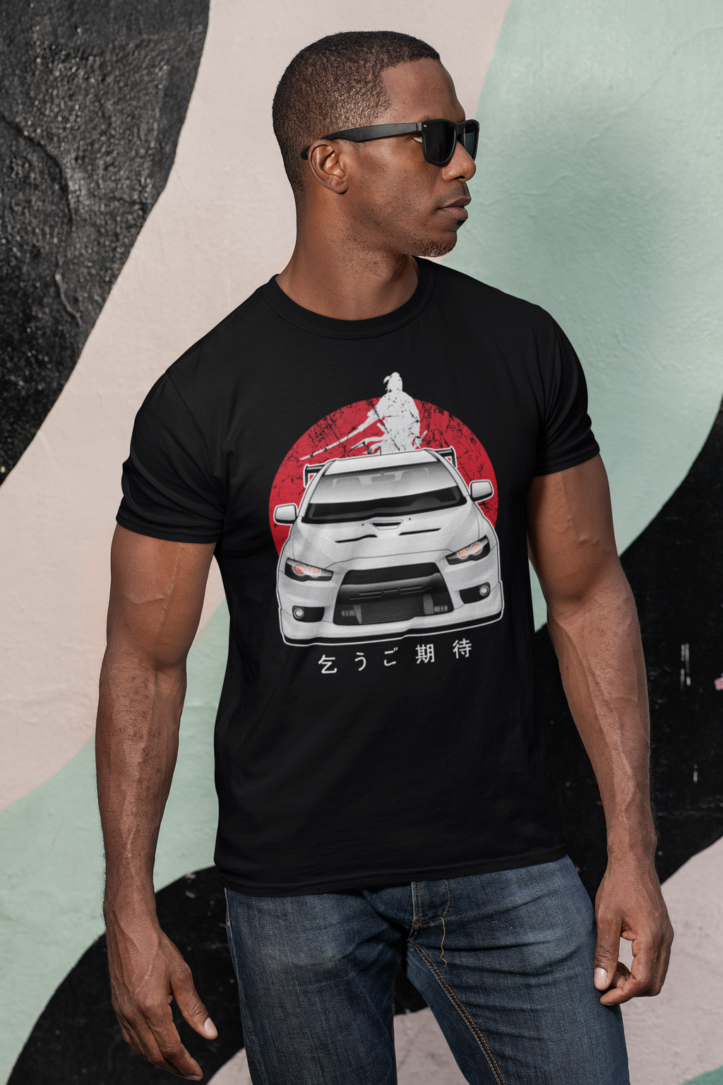 Man wearing a black Mitsubishi Evo t shirt in car clothing - Modified Street Style